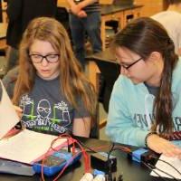 two students working on circuits